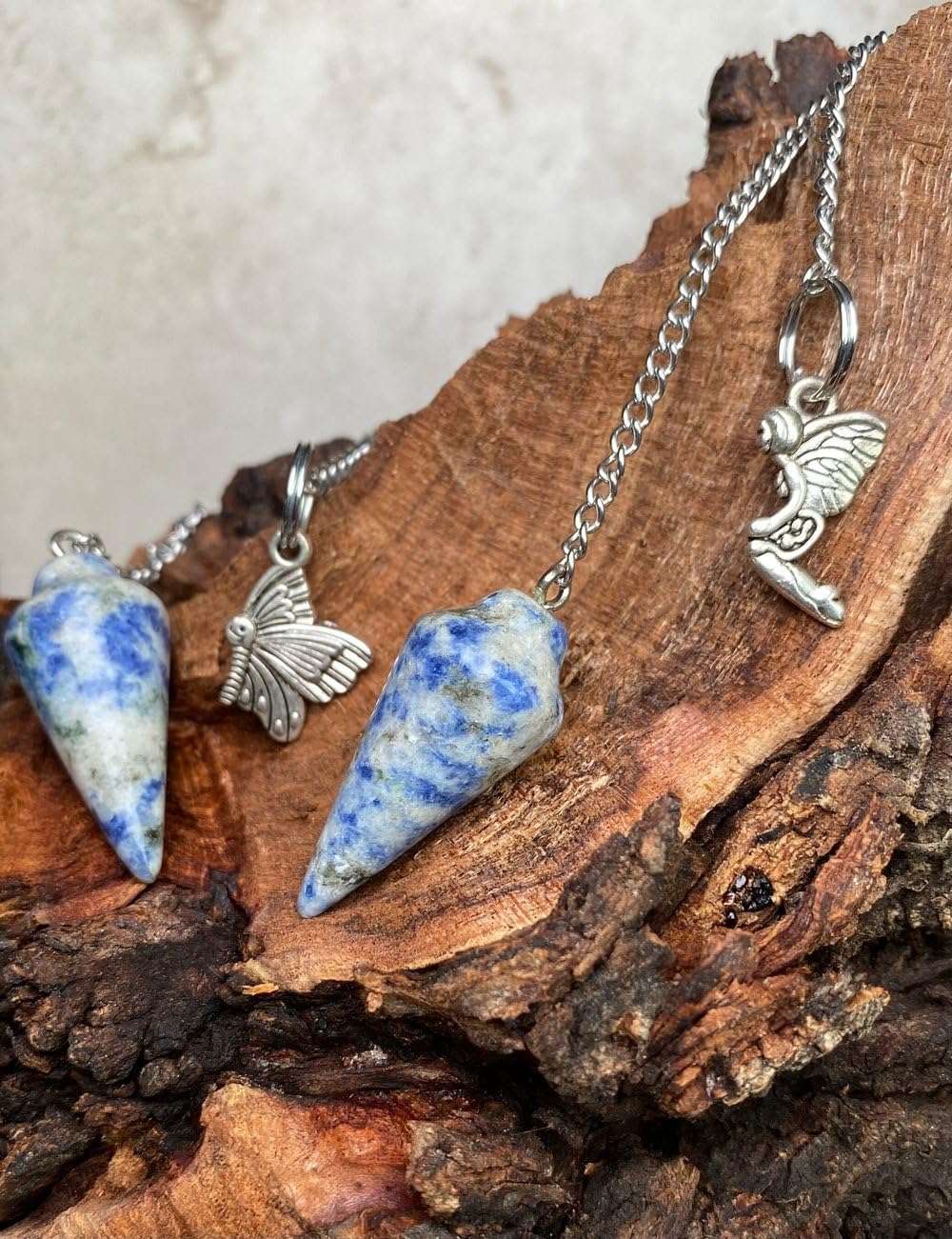 Blue gemstone crystal pendulum with silver chain and butterfly and rabbit charms