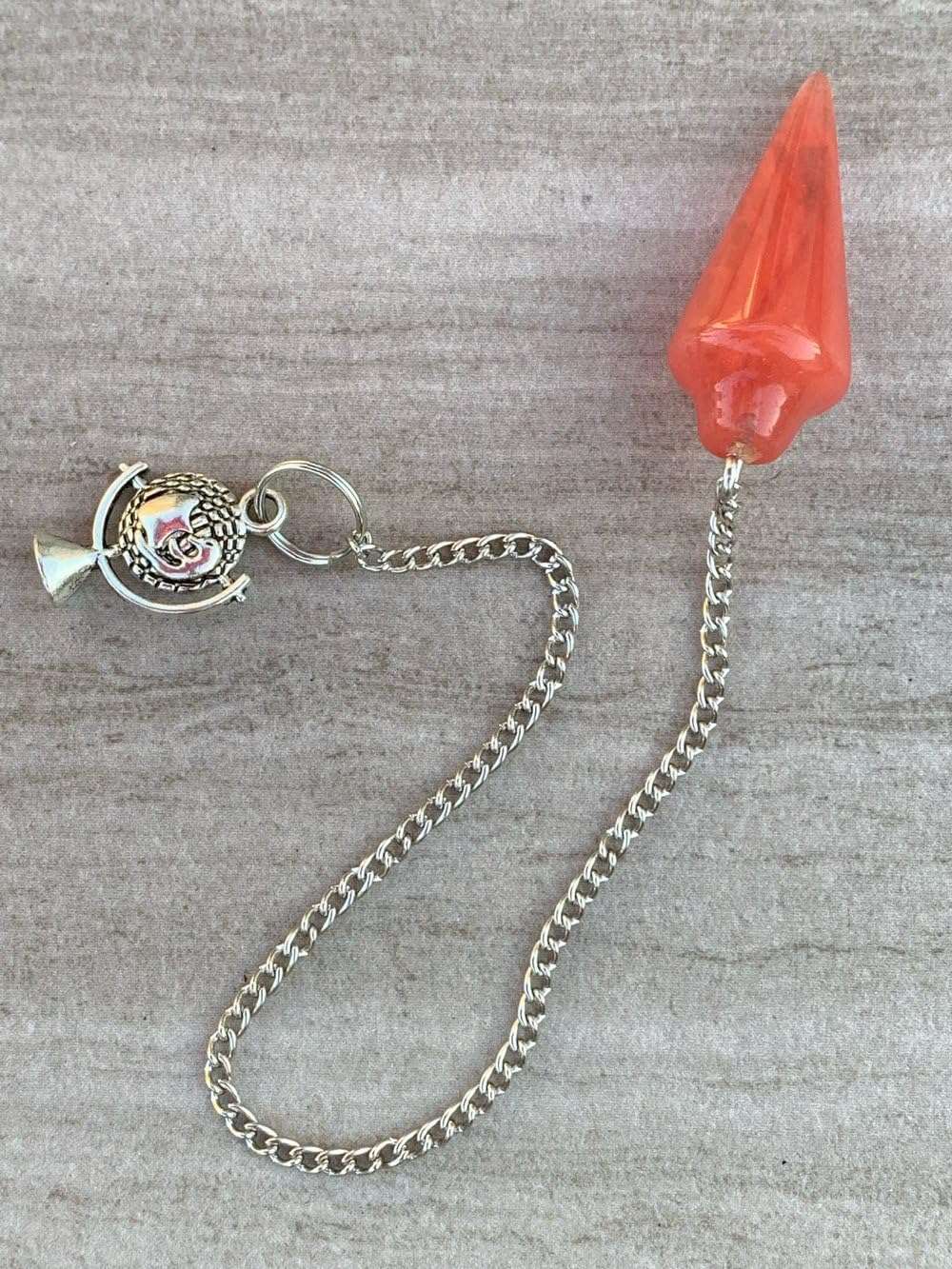 Red glass teardrop pendulum bag charm with silver-tone chain and split ring.