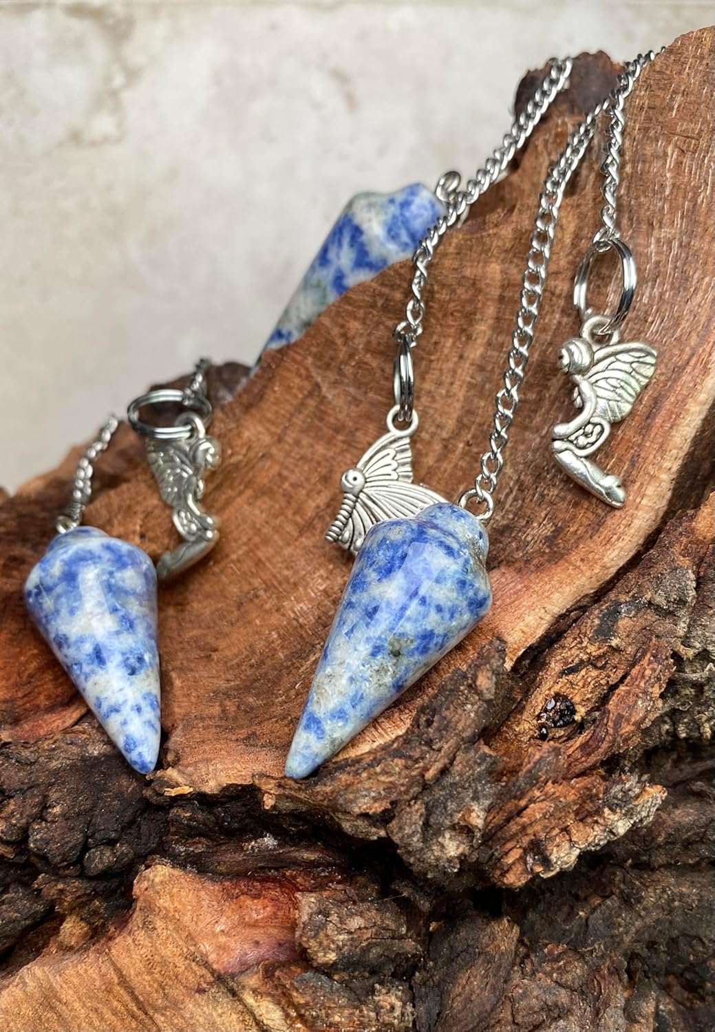 Blue gemstone pendulum bag charms with silver chains and angel charm dangles