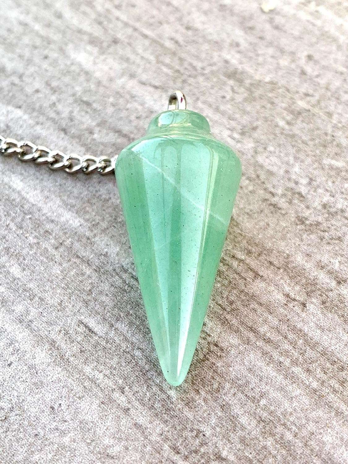 Green aventurine pendulum charm with silver loop top and faceted teardrop shape