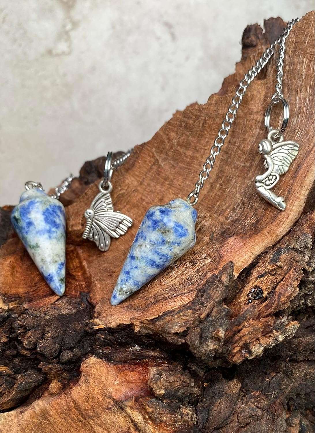 Blue gemstone pendulum bag charms with silver chains and small angel charms