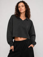 Dark gray cropped V-neck sweatshirt with long sleeves and ribbed cuffs