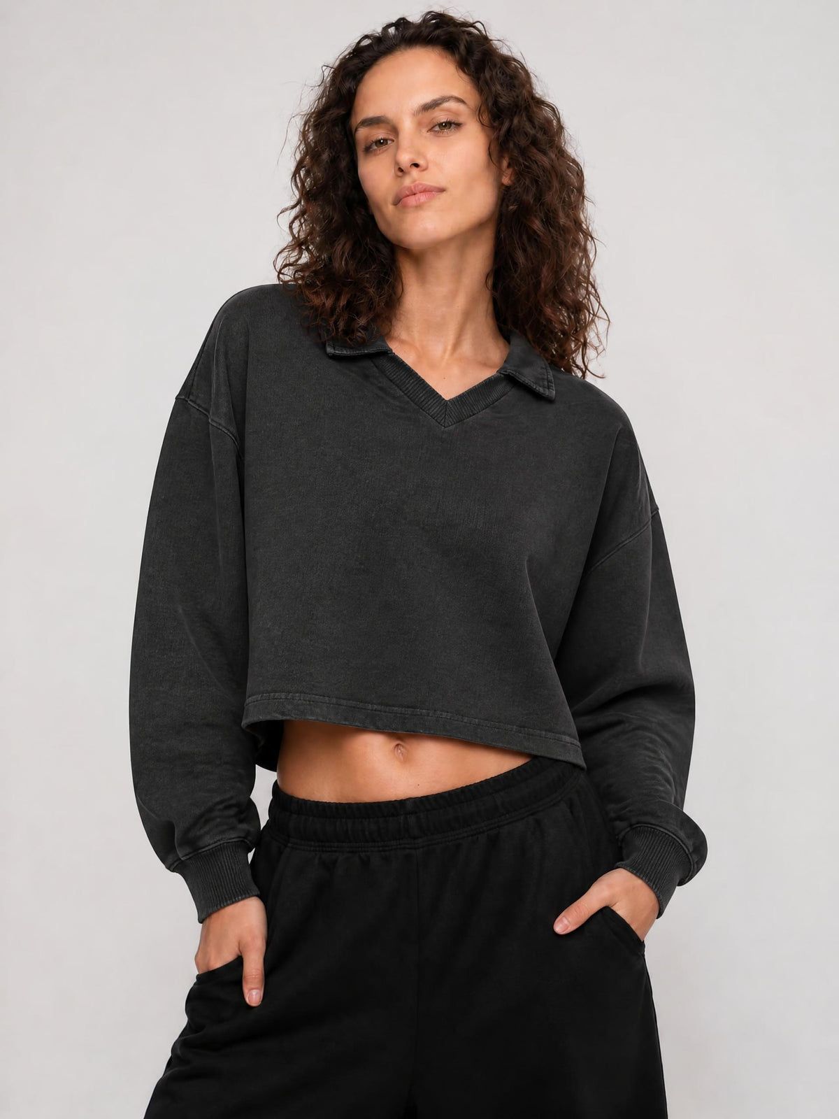 Dark gray cropped V-neck sweatshirt with long sleeves and ribbed cuffs