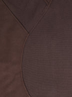 Cropped half-zip hoodie seam and ribbed fabric texture detail in dark brown
