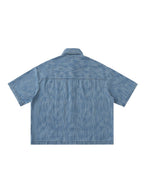 Distressed blue short-sleeve button-up shirt, back view with yoke seam