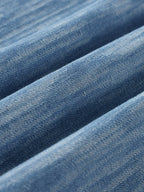 Distressed blue shirt fabric texture and close seam detail