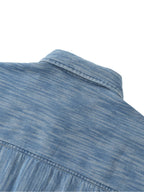 Distressed blue shirt shoulder yoke and collar close-up