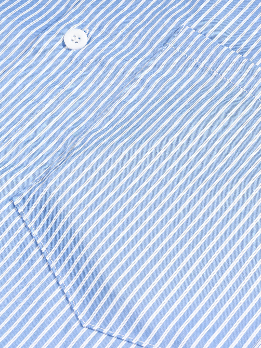 Blue vertical stripe boxy shirt with white button and curved hem detail.