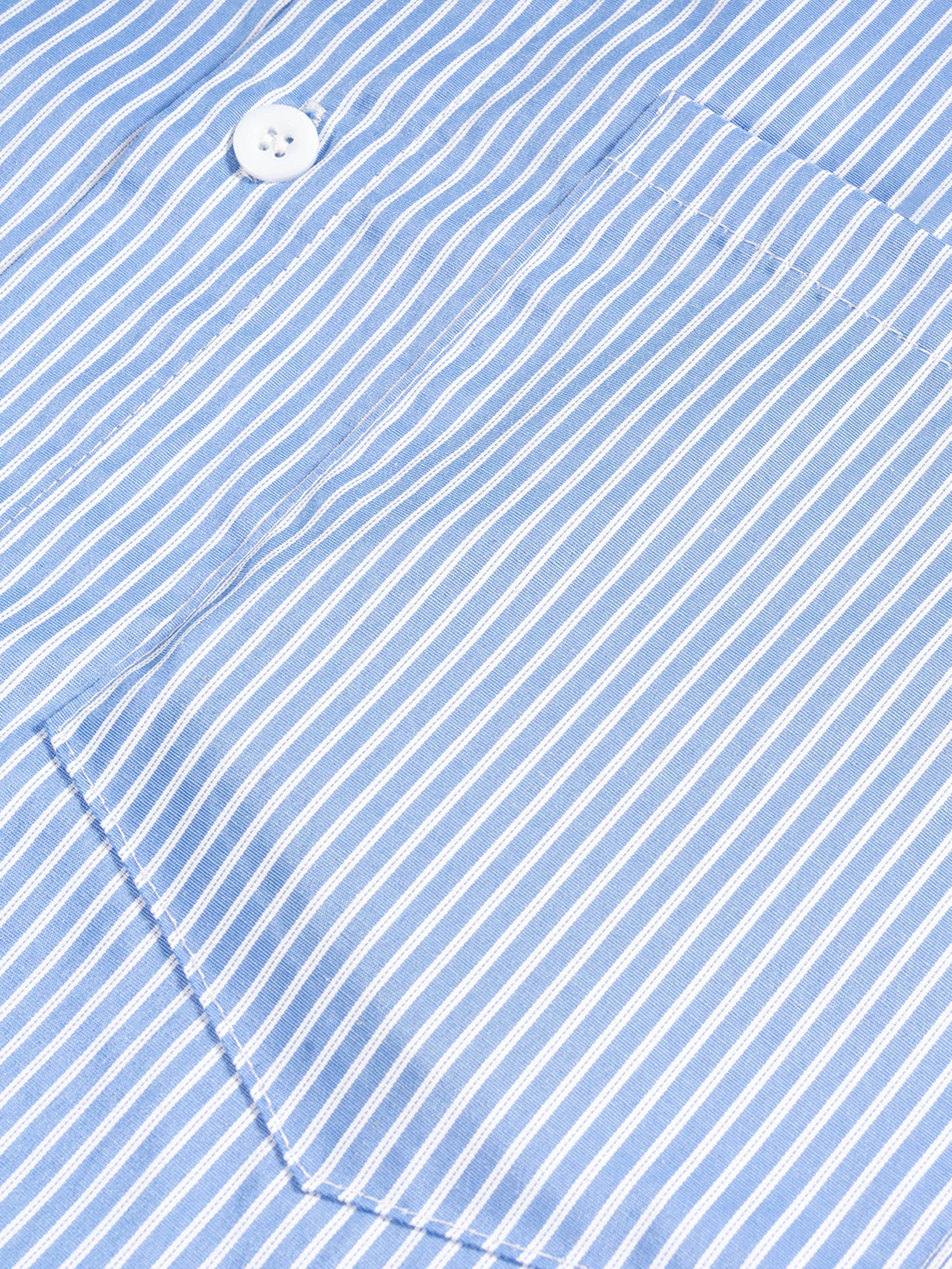 Blue vertical stripe boxy shirt with white button and curved hem detail.