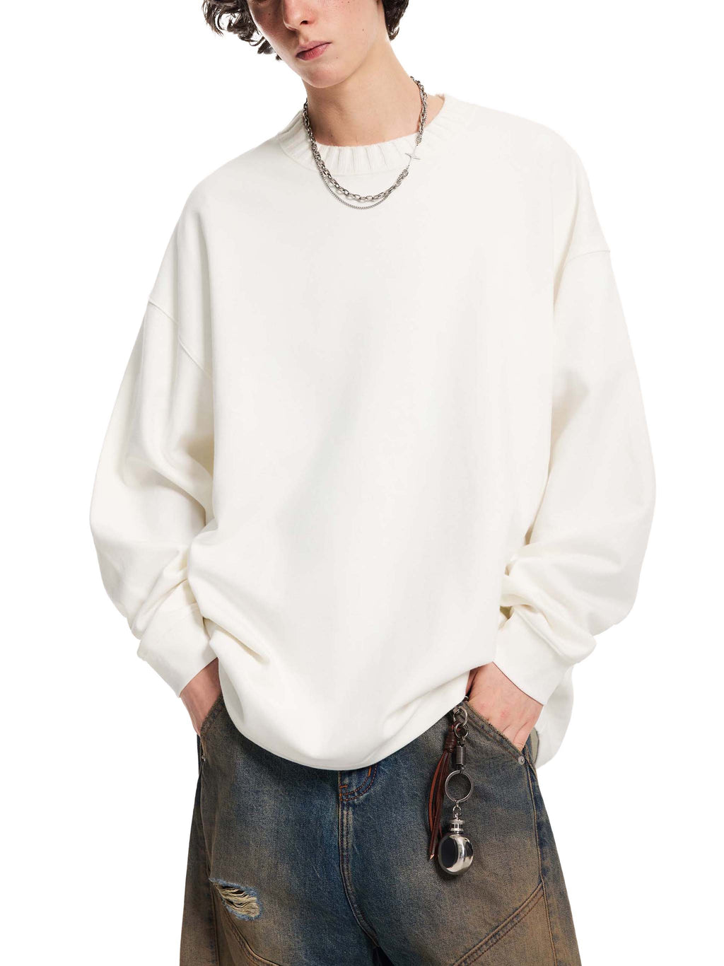 White oversized knit sweatshirt with round neckline, long sleeves, relaxed fit