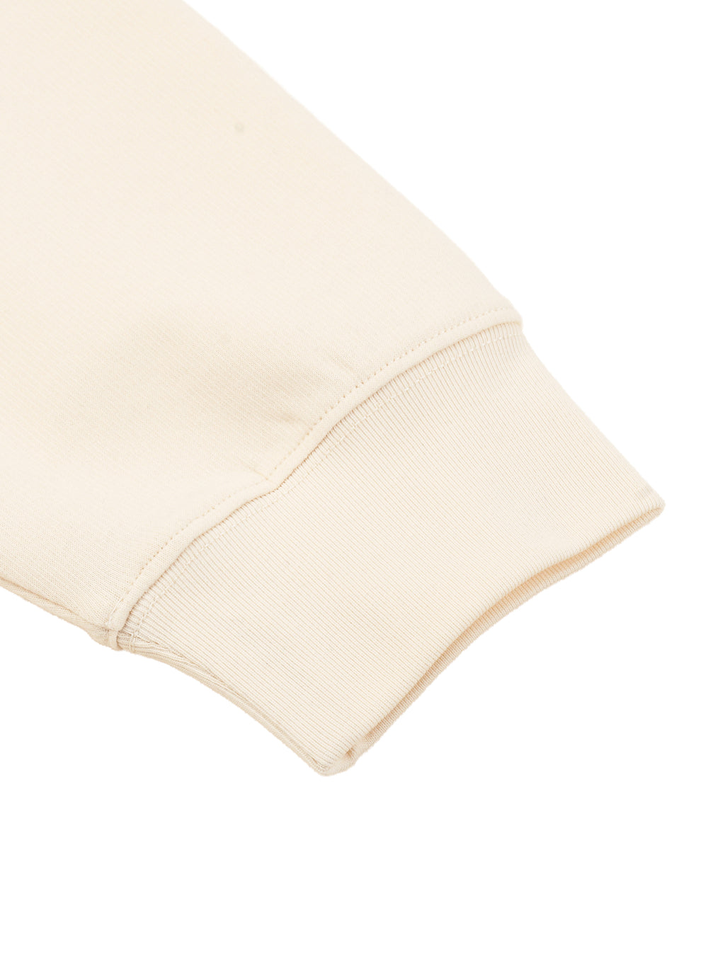 Cream knit sweatshirt sleeve cuff with ribbed cuff and clean stitched edge