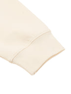 Cream knit sweatshirt sleeve cuff with ribbed cuff and clean stitched edge