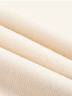 Cream knit fabric close-up showing fine row texture and smooth drape