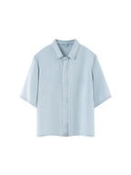 Light blue lyocell drop-shoulder button-up shirt with pointed collar and short sleeves.
