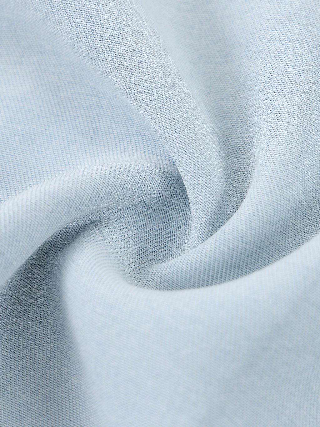 Light blue lyocell fabric close-up with textured weave and soft drape