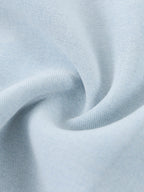 Light blue lyocell fabric close-up with textured weave and soft drape