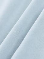 Light blue lyocell fabric close-up showing fine knit texture