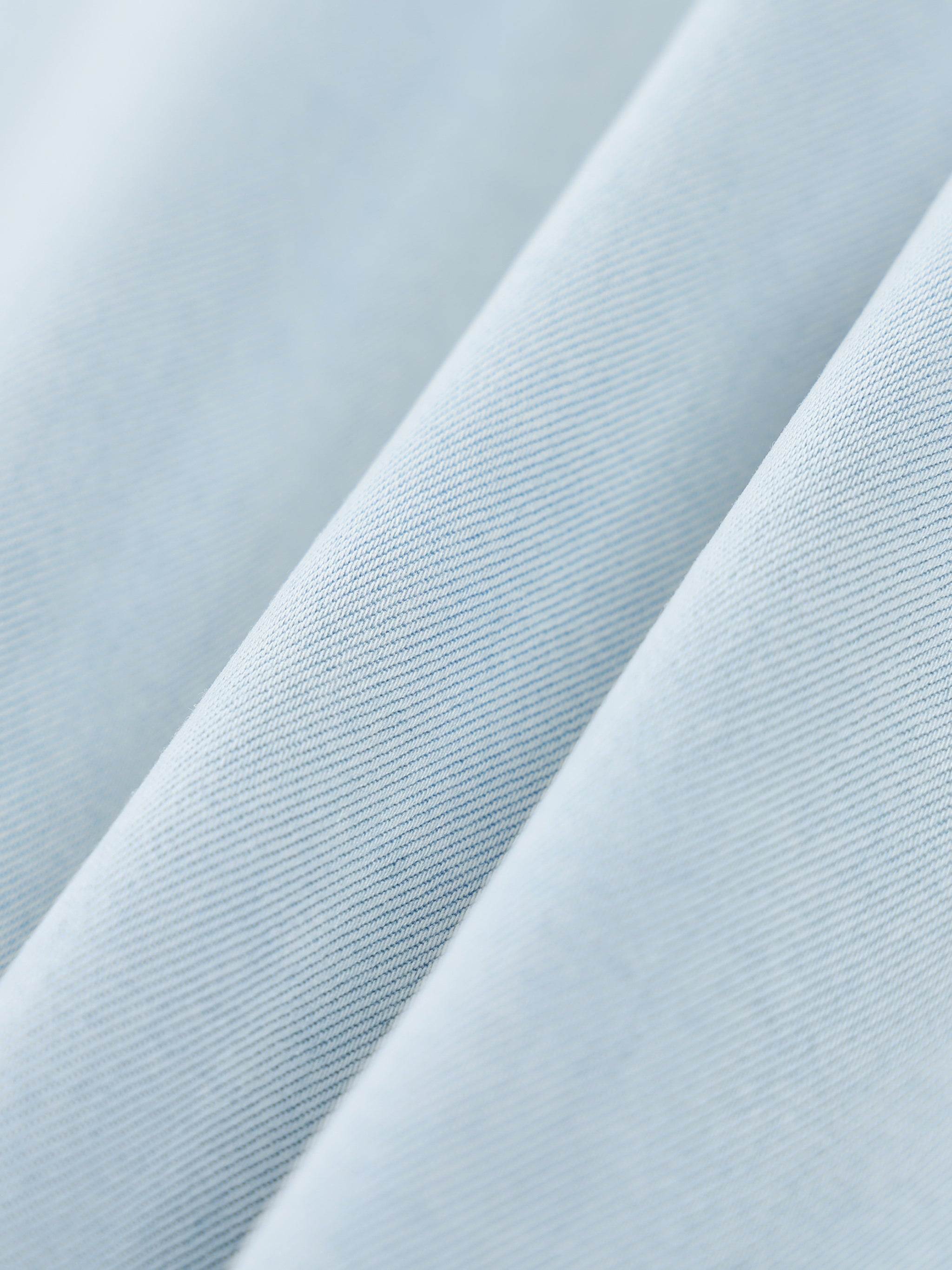 Light blue lyocell fabric close-up showing fine knit texture