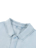 Light blue shirt collar and button placket close-up with vintage-wash finish