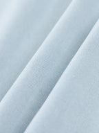 Light blue woven fabric close-up showing fine texture and stitching