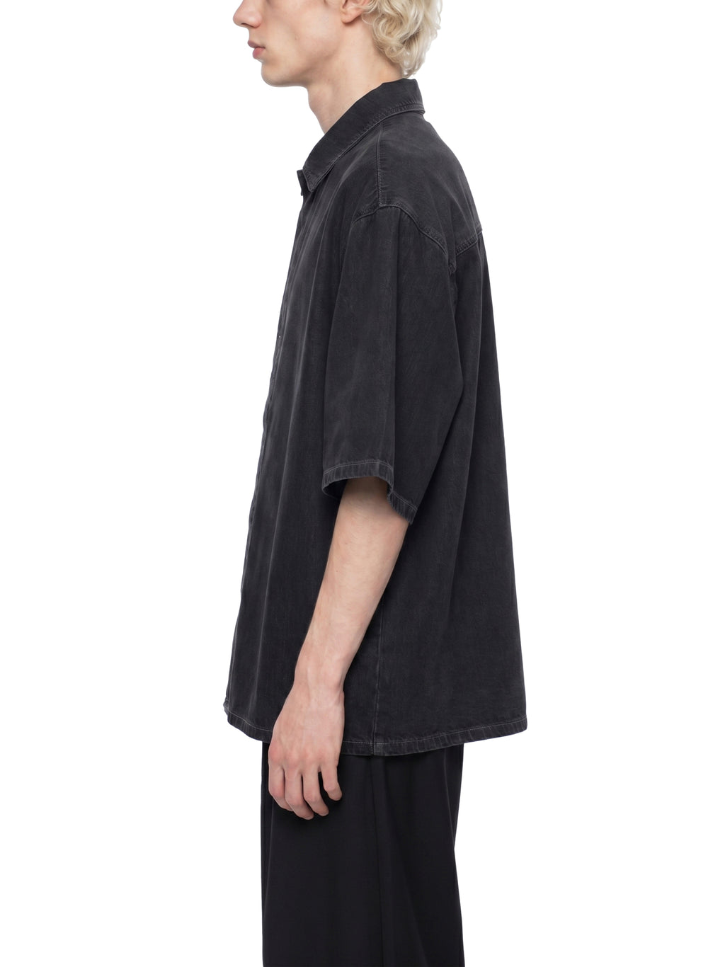 Black lyocell drop-shoulder button-up shirt, side view, short sleeves.