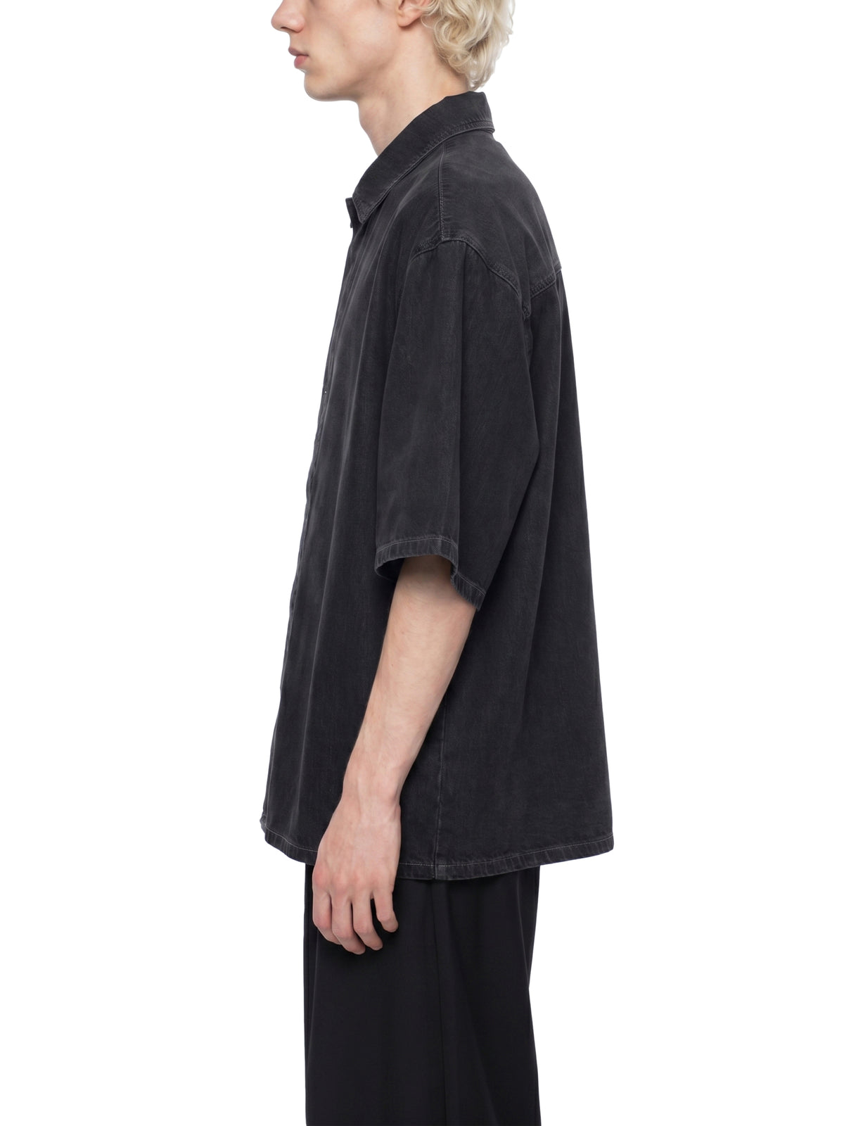 Black lyocell drop-shoulder button-up shirt, side view, short sleeves.
