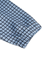 Sky blue plaid fabric swatch with stitched grid pattern