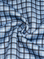 Sky blue plaid sweatshirt fabric close-up with stitched seams