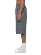 Navy blue plaid drawstring shorts on model, side view with elastic waistband and hem
