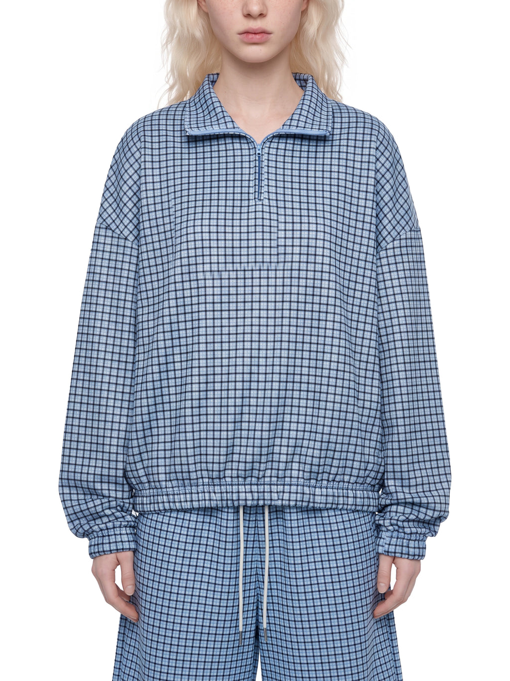 Sky blue plaid quarter-zip sweatshirt with collared zipper and elastic waist hem