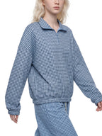 Sky blue plaid quarter-zip sweatshirt with collared neckline and ribbed cuffs