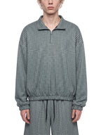 Mens plaid quarter-zip sweatshirt in dark green, worn front view, model torso
