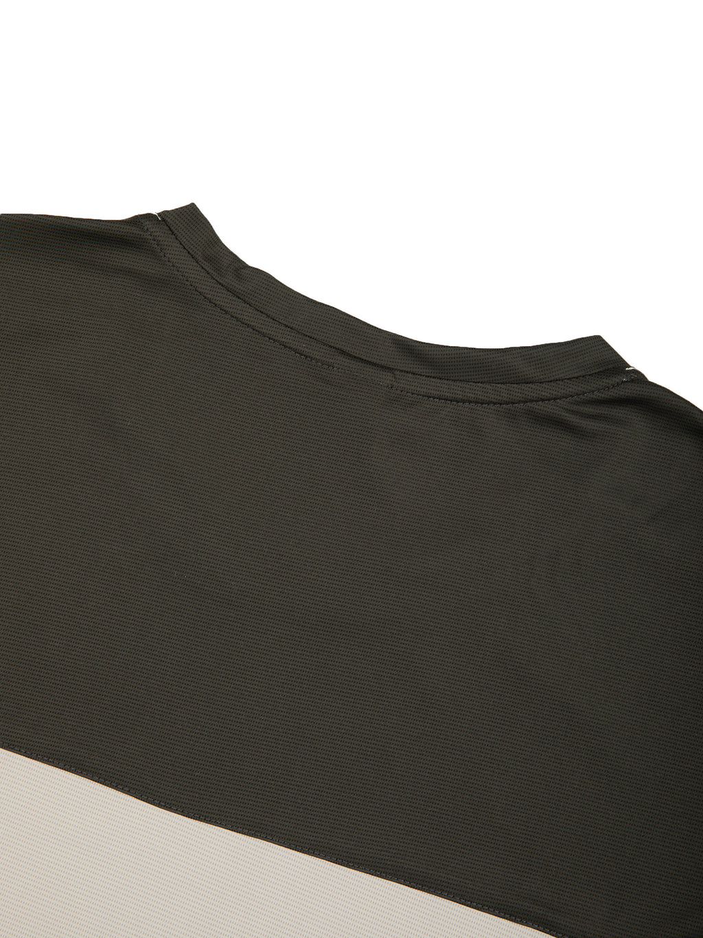 Close-up of color-block panel on dark charcoal top with beige contrast band