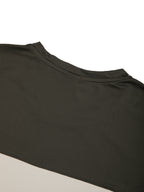 Close-up of color-block panel on dark charcoal top with beige contrast band