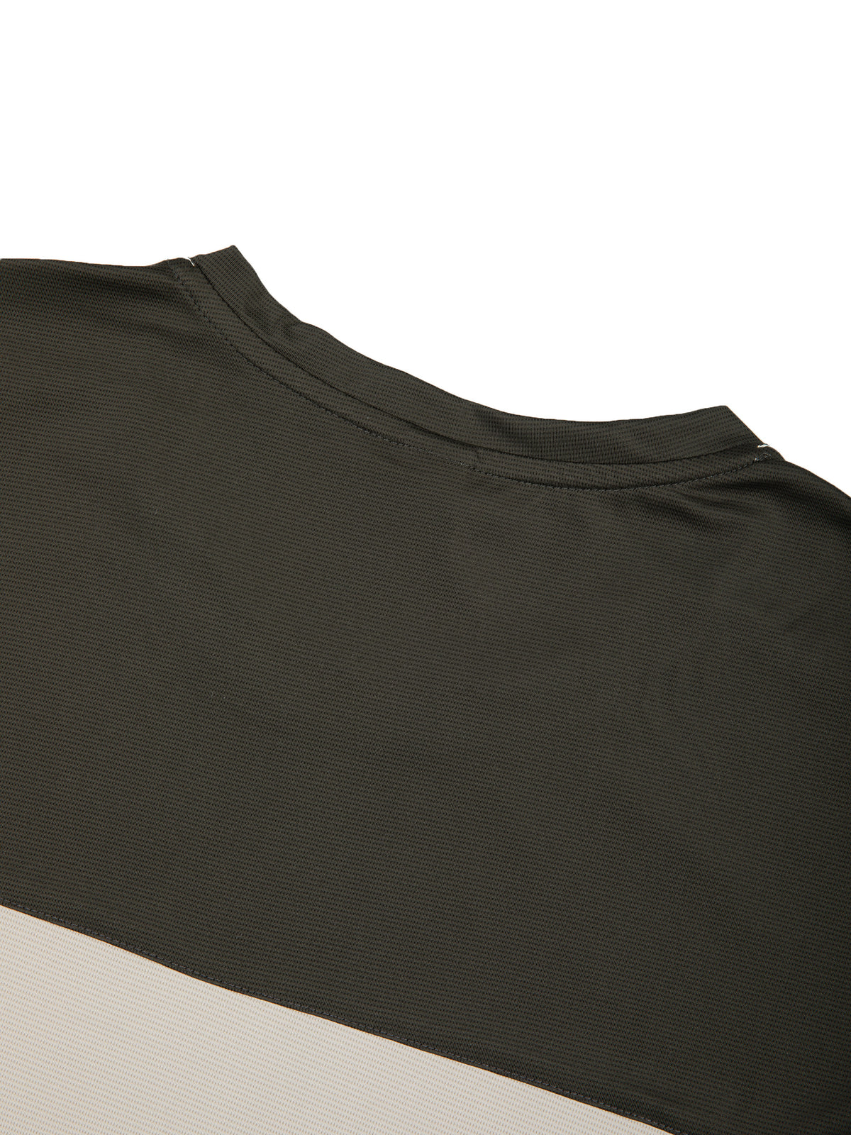 Close-up of color-block panel on dark charcoal top with beige contrast band