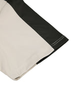 Short sleeve hem detail on color-block performance T-shirt, dark stripe and beige