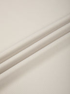 Fabric close-up of light beige performance T-shirt with fine textured knit