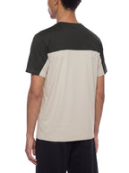 Back view of color-block performance T-shirt: dark charcoal upper, beige lower panel