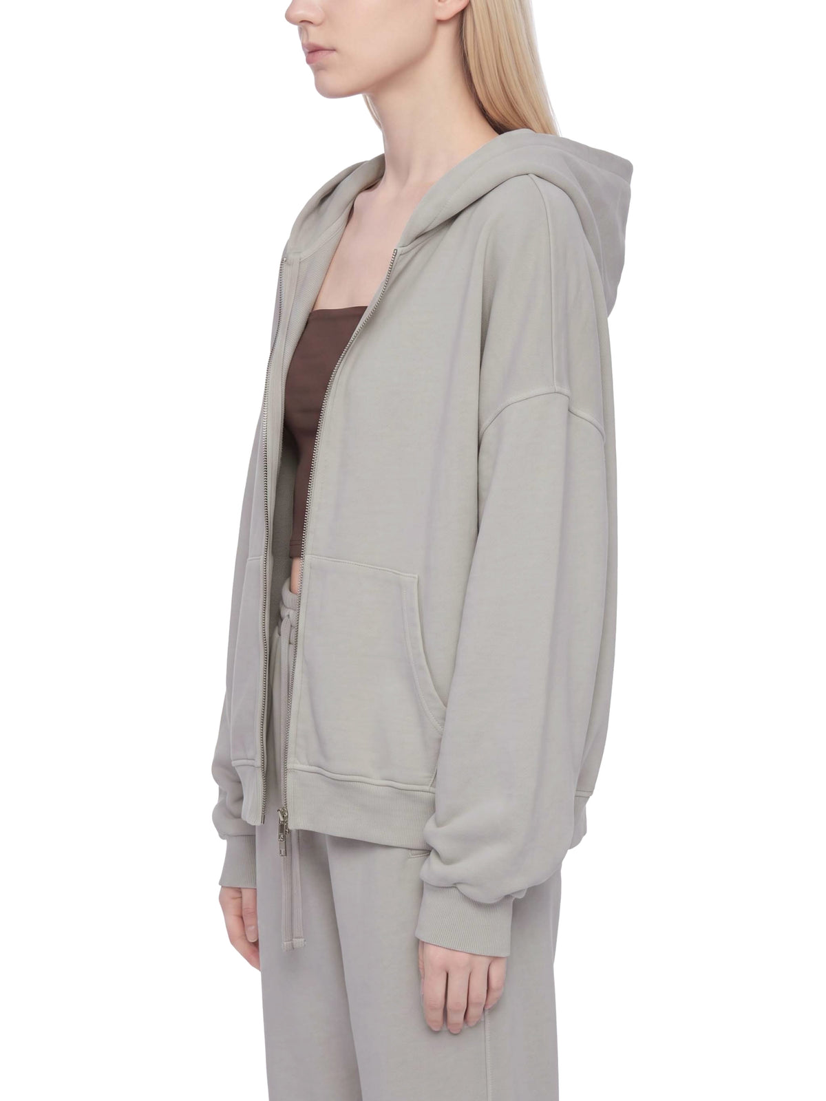 Light gray full-zip boxy hoodie with hood, kangaroo pocket, and ribbed cuffs (side view)