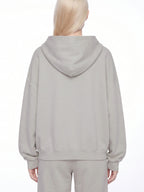 Light gray full-zip boxy hoodie with hood and ribbed hem, back view