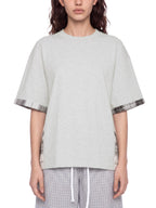 Unisex light gray T-shirt with plaid-trim sleeve cuffs and longer hemside panel