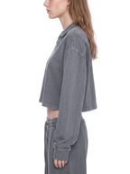Gray vintage wash crop sweatshirt on model, side view with long sleeves and ribbed cuffs