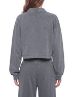 Model wearing a gray vintage wash crop sweatshirt, back view with ribbed cuffs