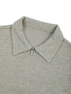 Oat gray quarter-zip sweatshirt with raised collar and zipper placket