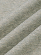 Oat gray heather knit fabric folds close-up, fine textured weave