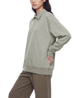 Unisex boxy quarter-zip sweatshirt, light gray, model wearing, collared zipper and ribbed hem