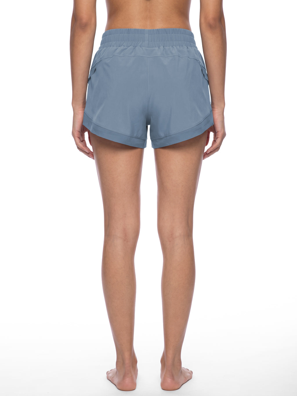 Women’s blue paneled yoga shorts from the back with elastic waistband