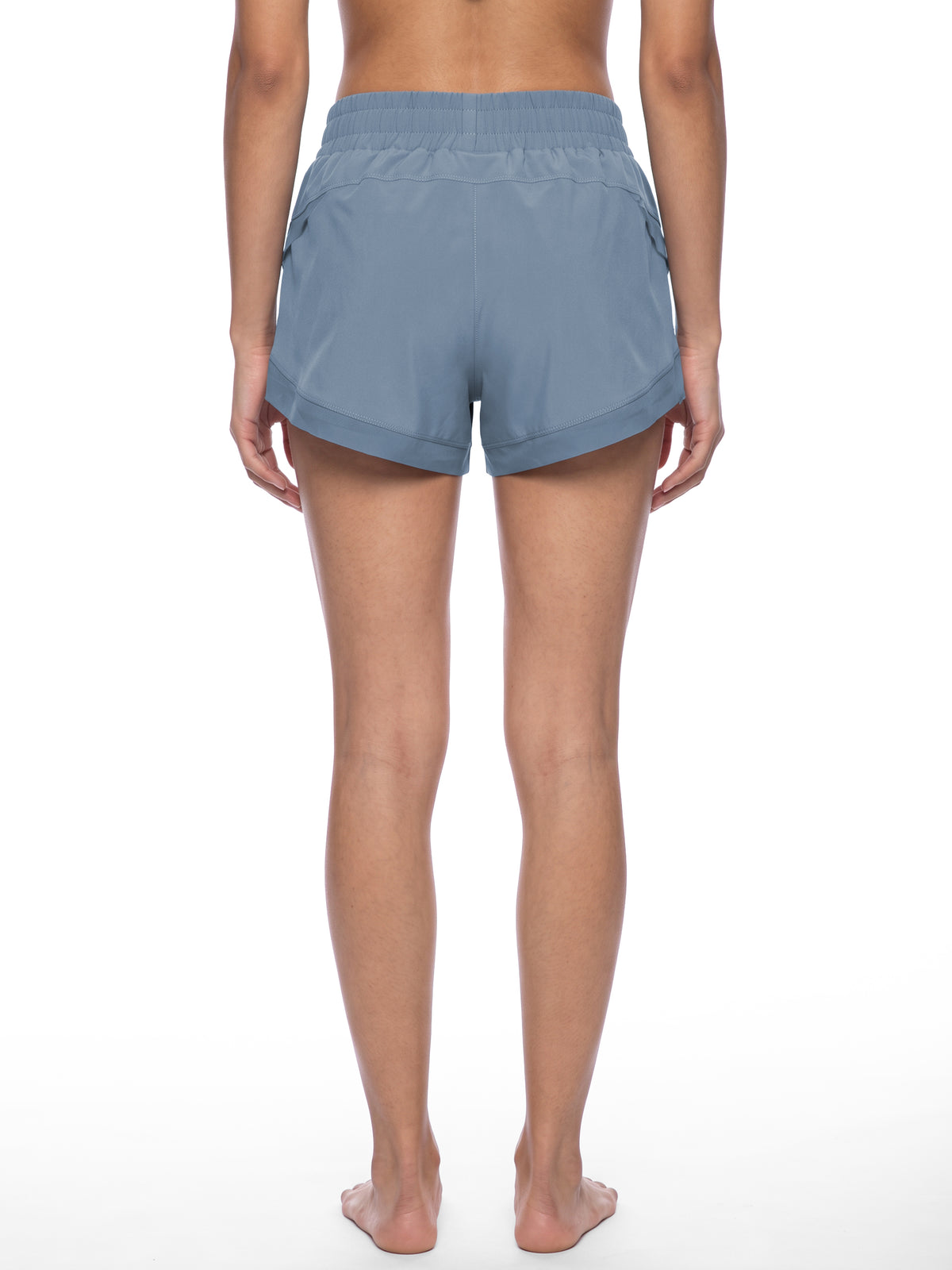 Women’s blue paneled yoga shorts from the back with elastic waistband