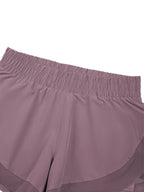 Women’s purple paneled yoga shorts with gathered elastic waistband
