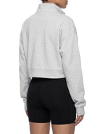 Light gray women’s crop quarter-zip sweatshirt, side/back view with zip-up neckline